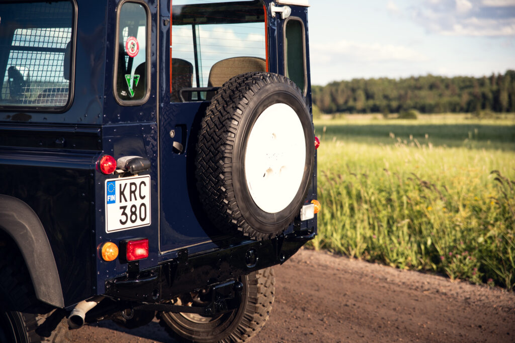 Rear of blue off-road vehicle on dirt road