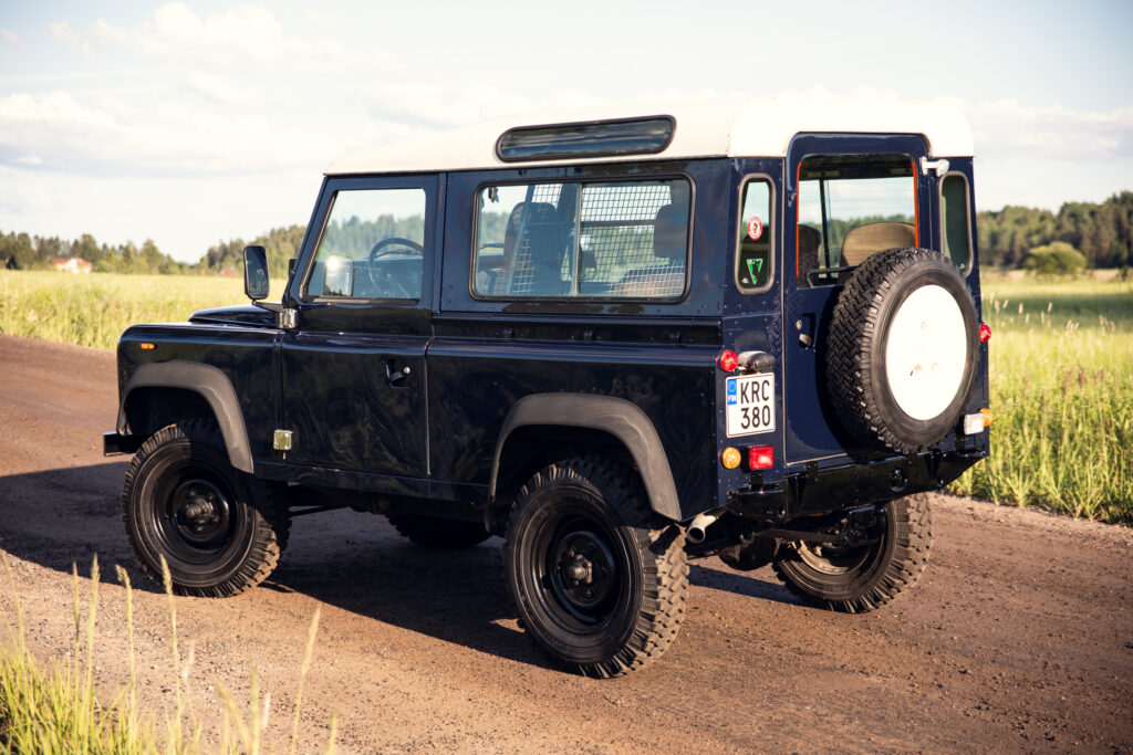 Classic blue Land Rover on rural dirt road