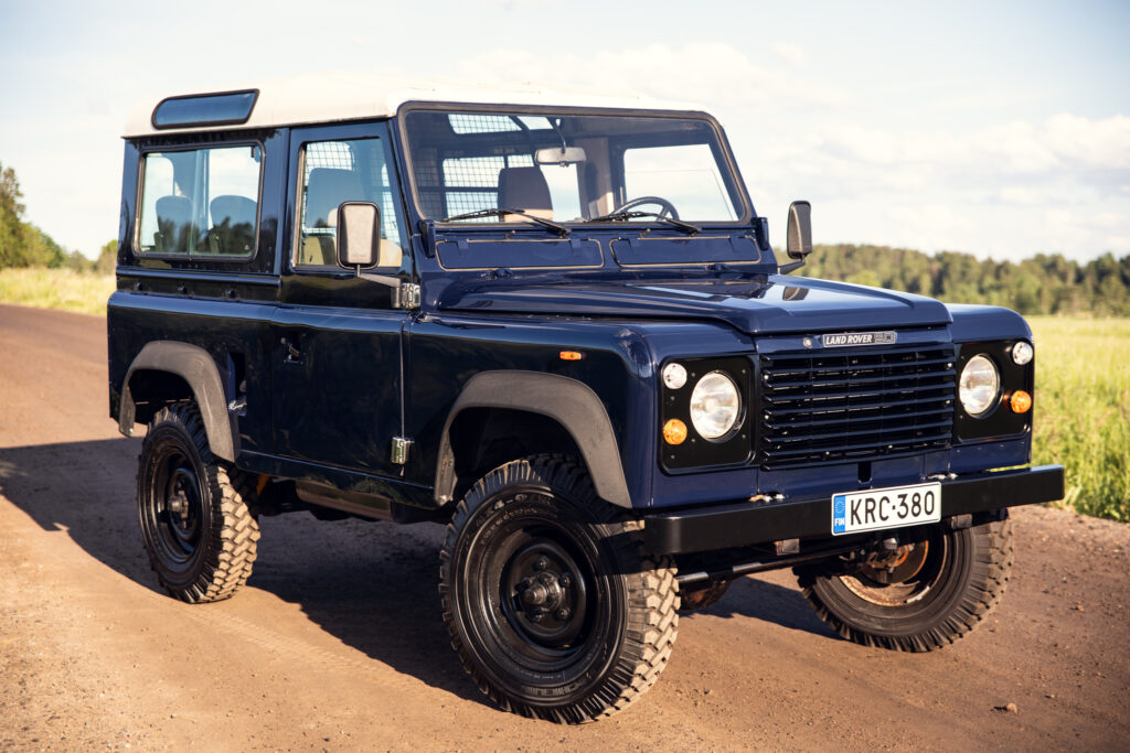 Classic blue Land Rover Defender on dirt road