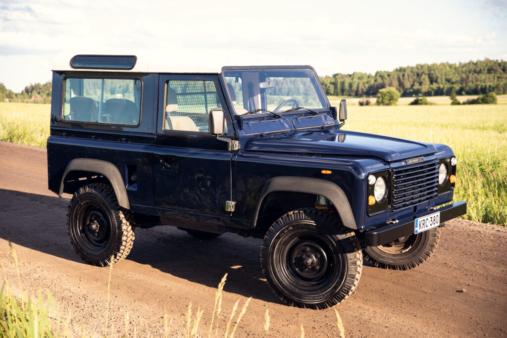 Classic blue Land Rover Defender on dirt road