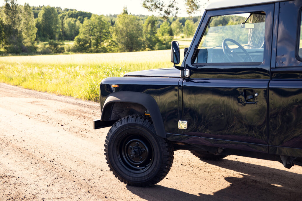 Black off-road vehicle on rural dirt road