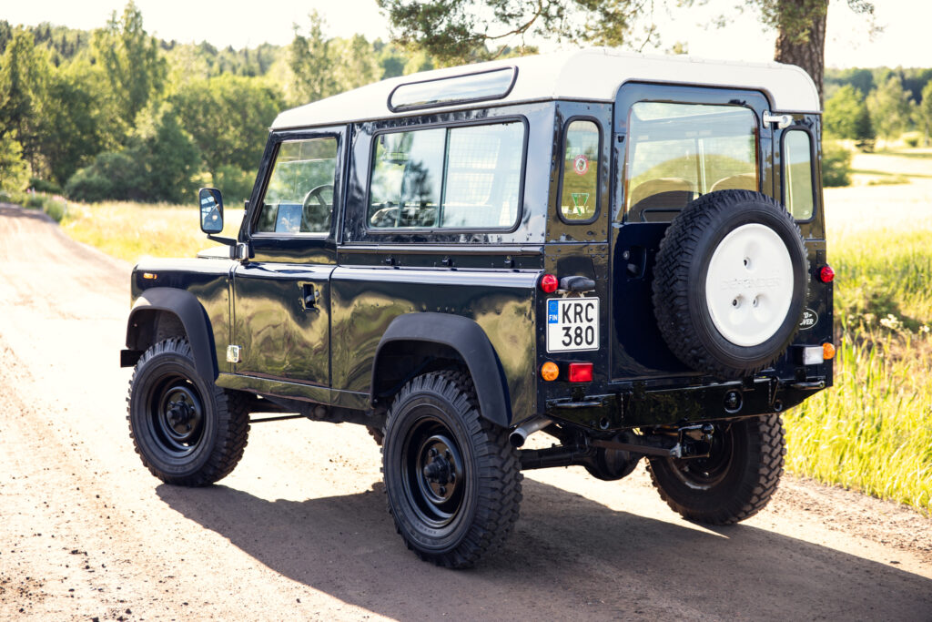 Black Land Rover Defender on dirt road
