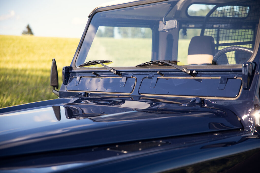 Close-up of blue off-road vehicle in field