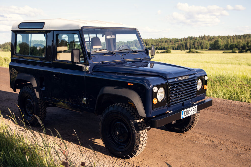 Classic blue Land Rover Defender on dirt road