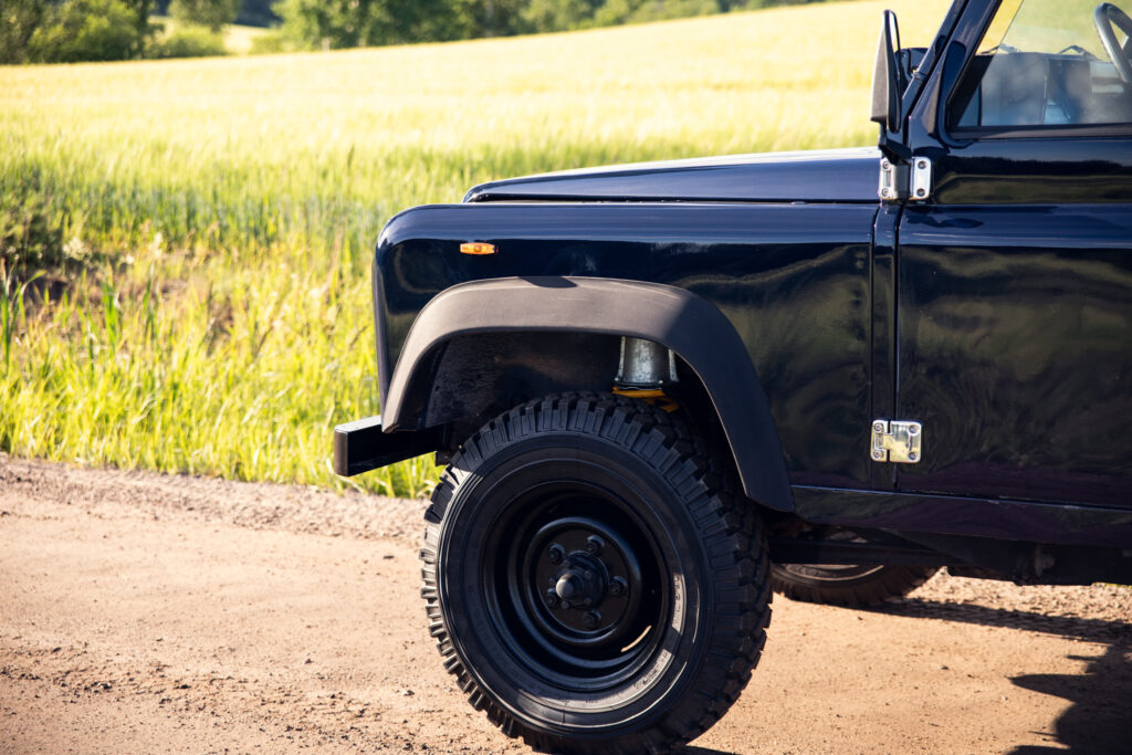Black off-road vehicle on rural dirt road