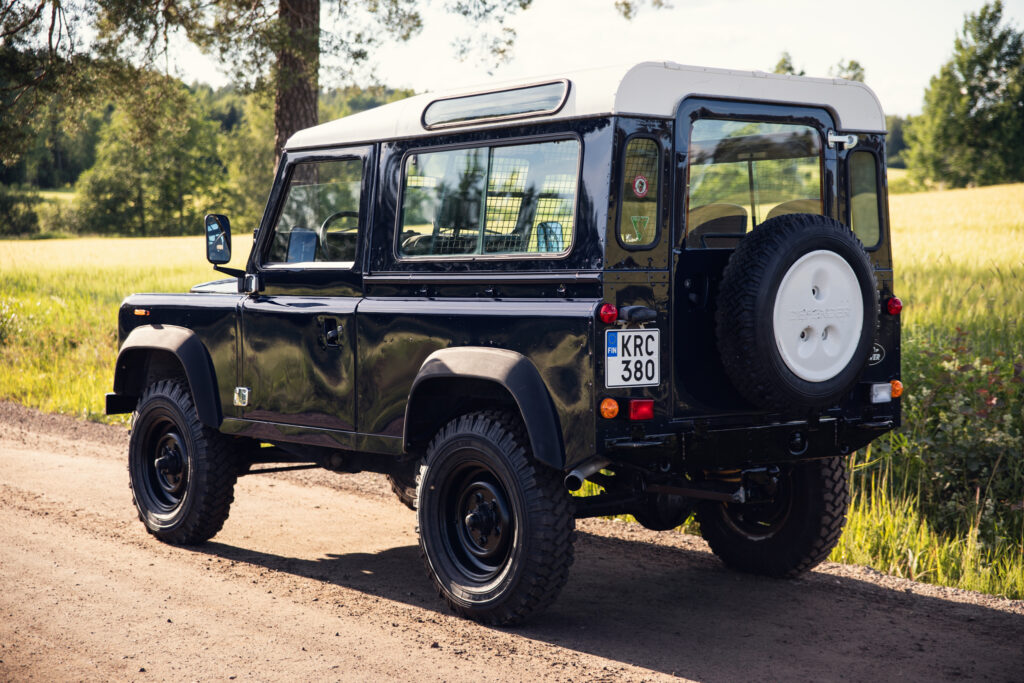 Black vintage Land Rover on rural dirt road