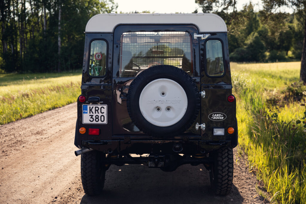 Rear view of Land Rover on dirt road