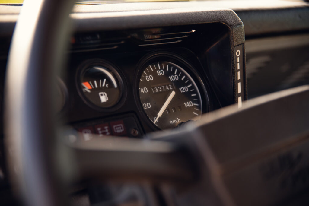 Close-up of car dashboard speedometer and fuel gauge