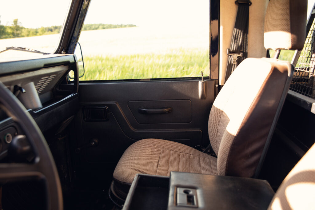 Front passenger seat of vehicle overlooking grassy field
