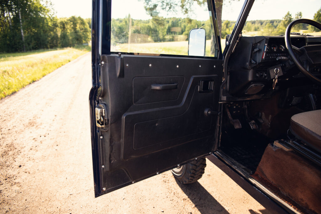 Open off-road vehicle door on rural dirt road