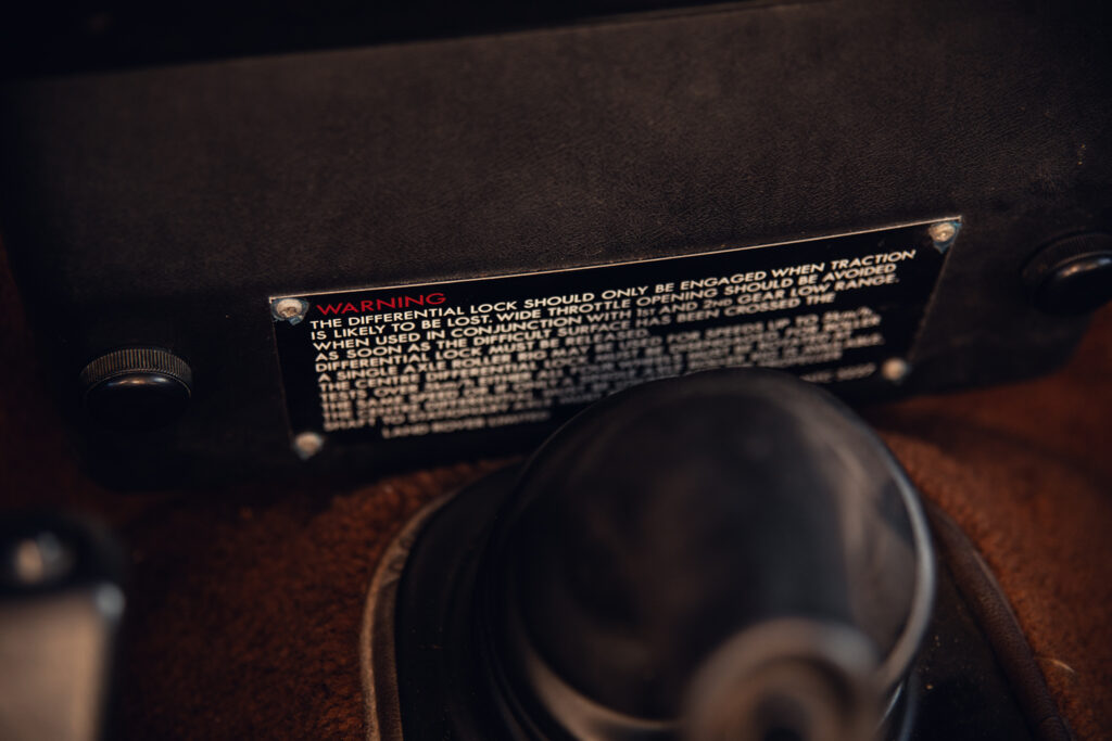 Close-up of vehicle gear shift and warning label