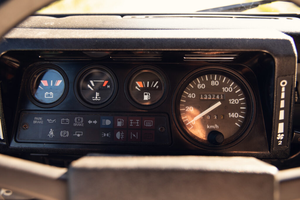 Car dashboard with speedometer and warning gauges