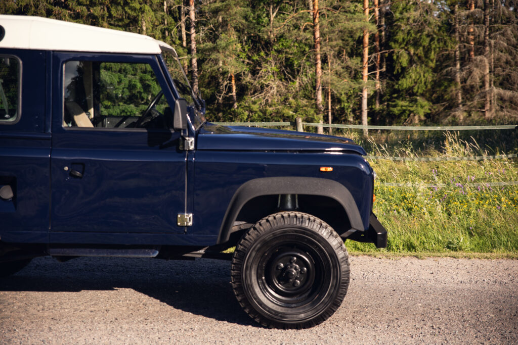 Blue off-road vehicle parked on rural gravel road