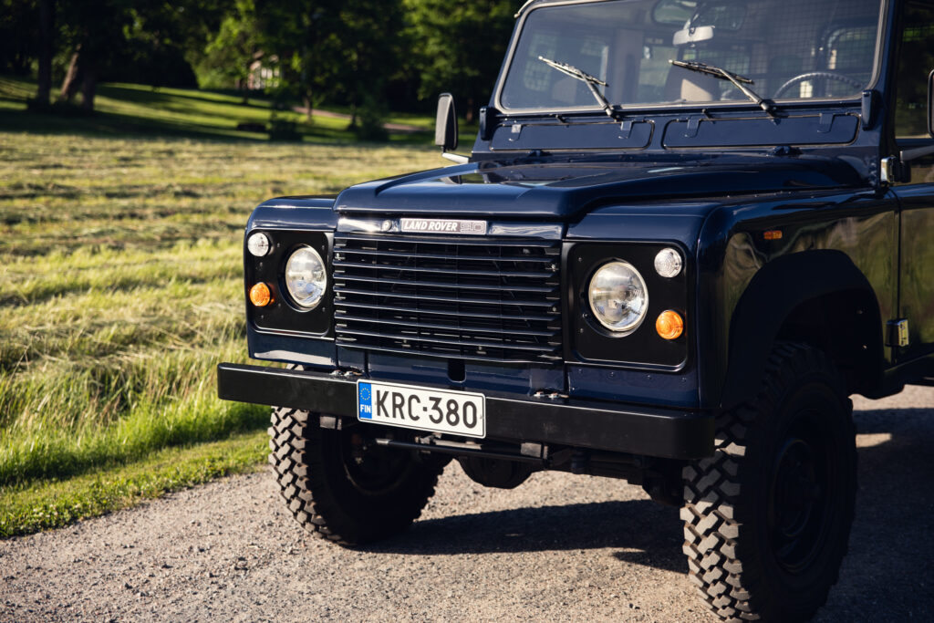 Classic Land Rover 90 parked on gravel road