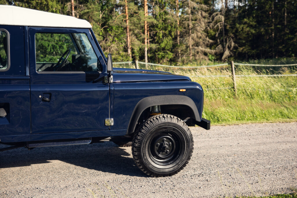 Blue vintage off-road SUV on gravel road