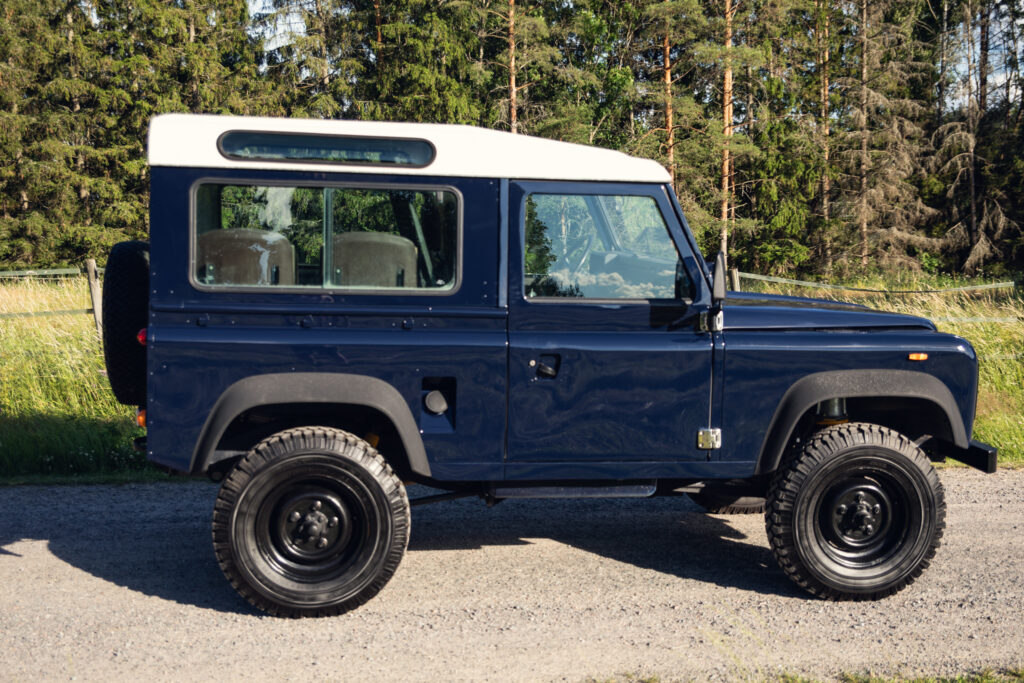 Classic blue Land Rover Defender parked outdoors