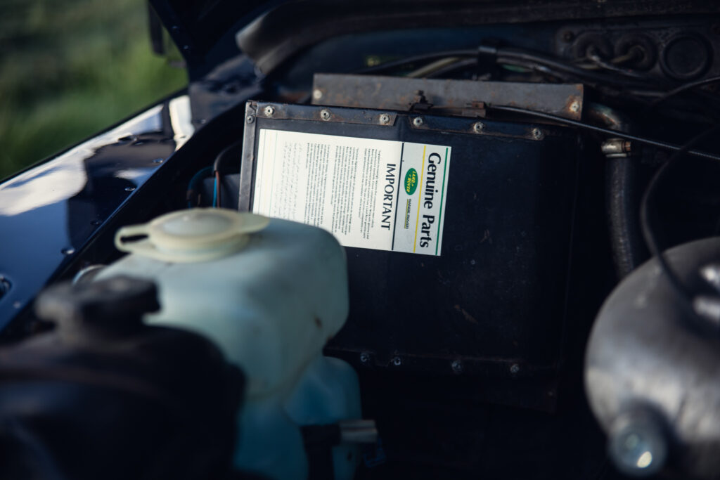 Car engine compartment with Genuine Parts label