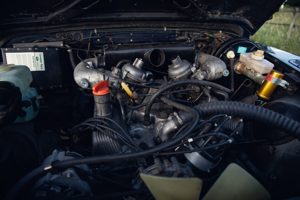 Classic car engine with dual carburetors and hoses
