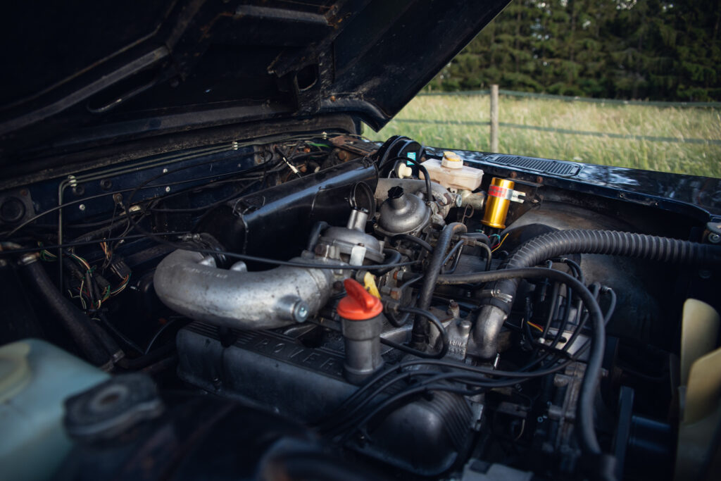 Classic car engine under open hood