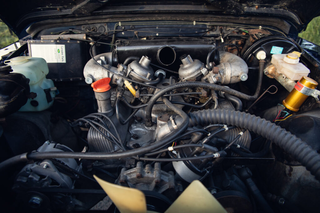 Classic car engine with dual carburetors and hoses
