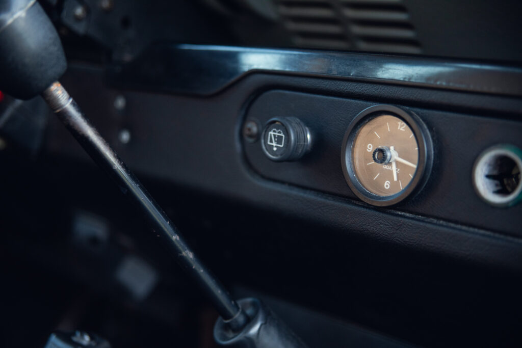 Vintage car dashboard with analog clock and gear shift