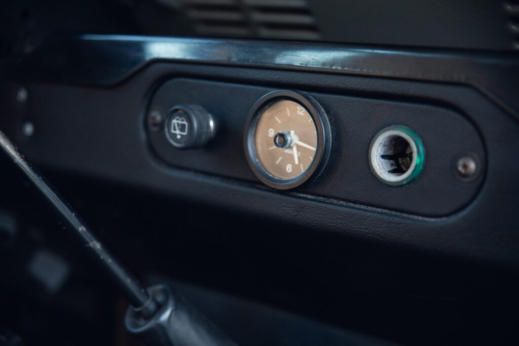 Vintage car dashboard with analog clock and controls