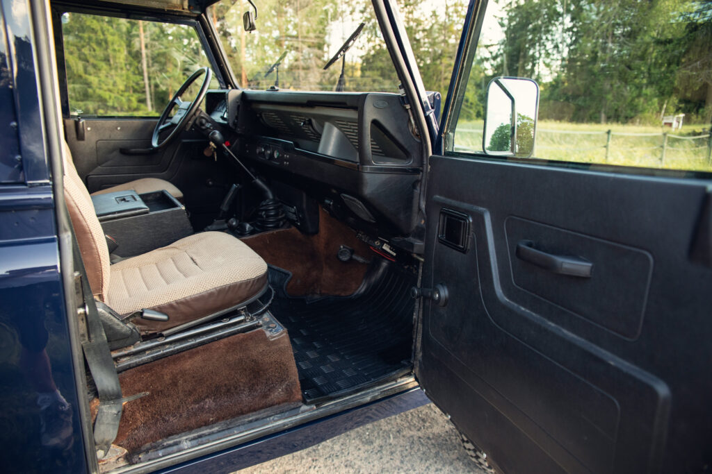Vintage SUV interior with manual transmission and open door