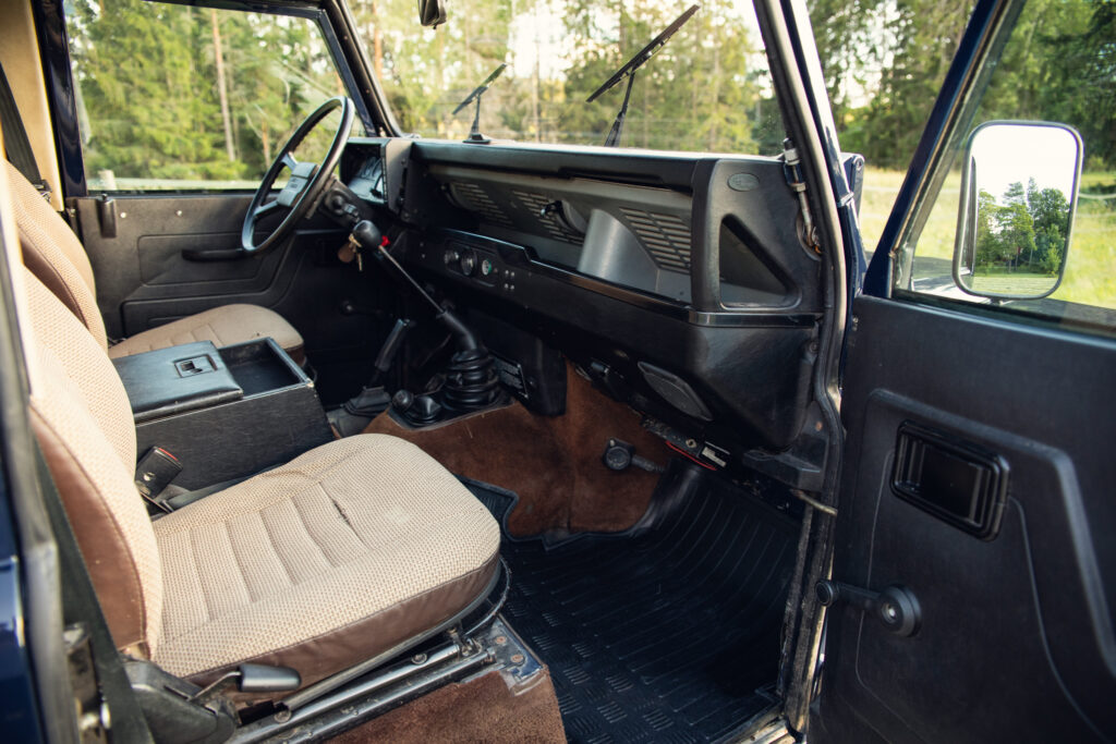 Vintage SUV interior with manual transmission and beige seats