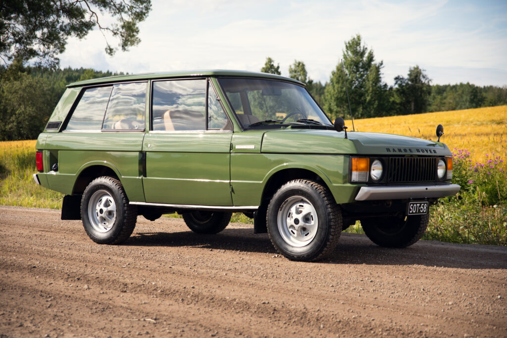 Classic green Range Rover in rural countryside