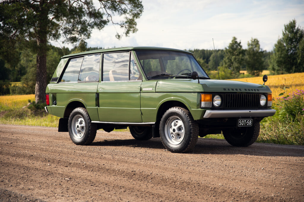Classic green Range Rover on rural dirt road