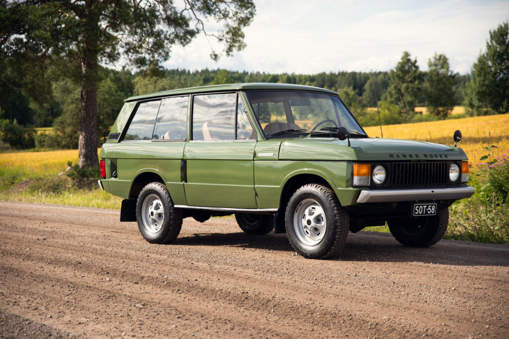 Vintage green Range Rover on rural dirt road