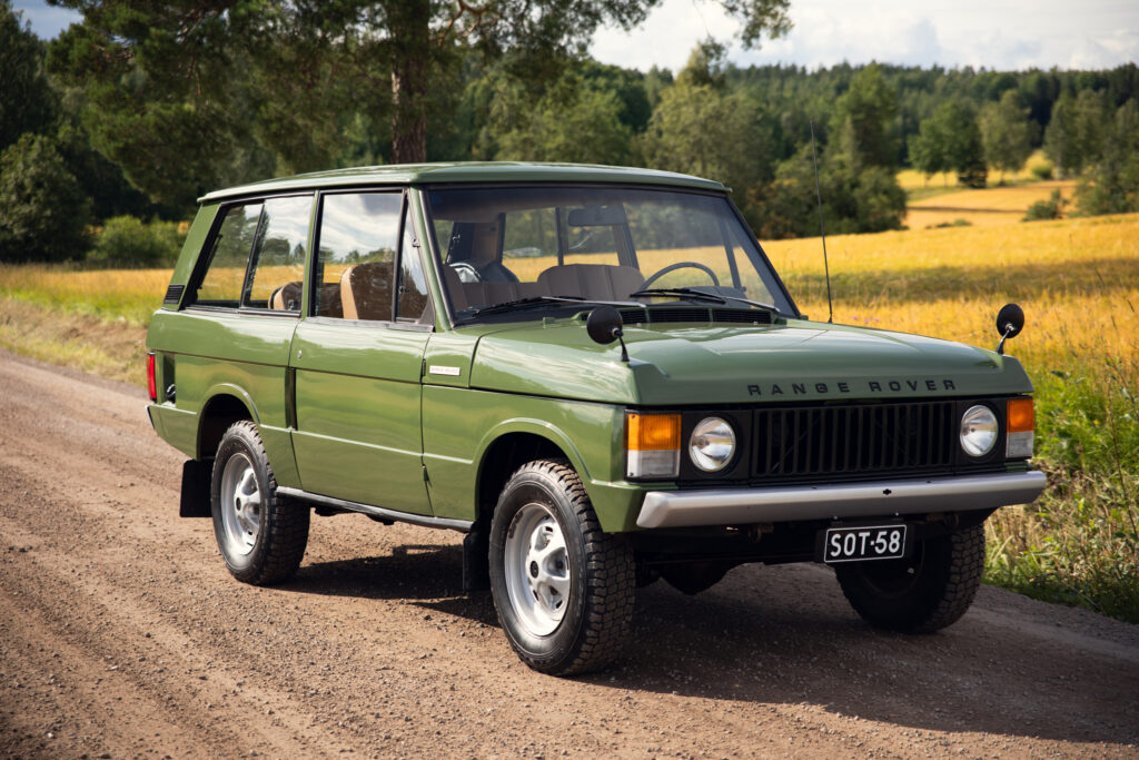 Vintage green Range Rover on rural dirt road