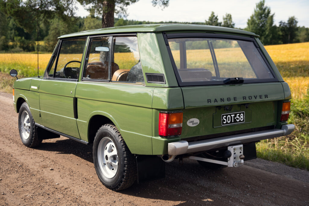 Classic green Range Rover on rural dirt road