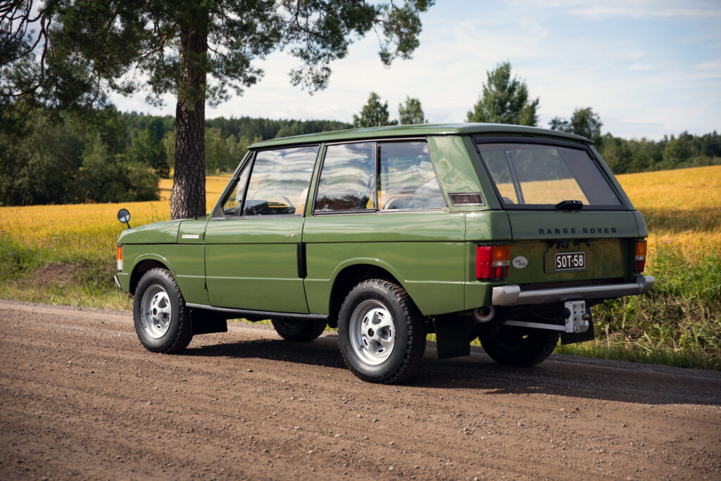 Vintage green Range Rover on country dirt road