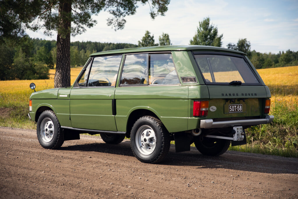 Vintage green Range Rover on rural dirt road
