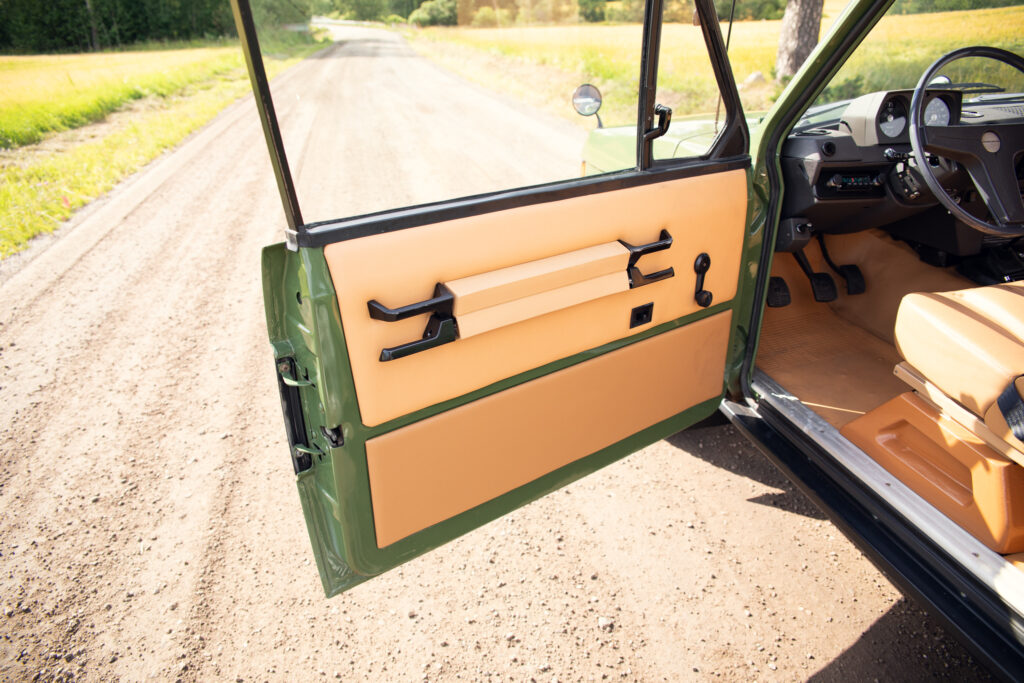 Open vintage car door on rural dirt road