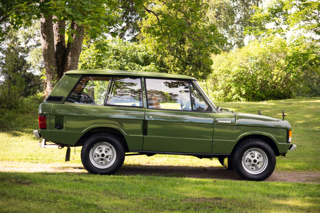 Classic green Range Rover parked on grass