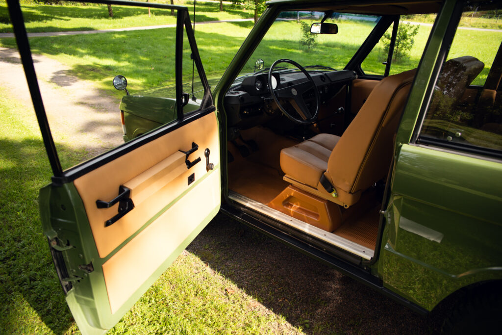 Open door of vintage green SUV interior