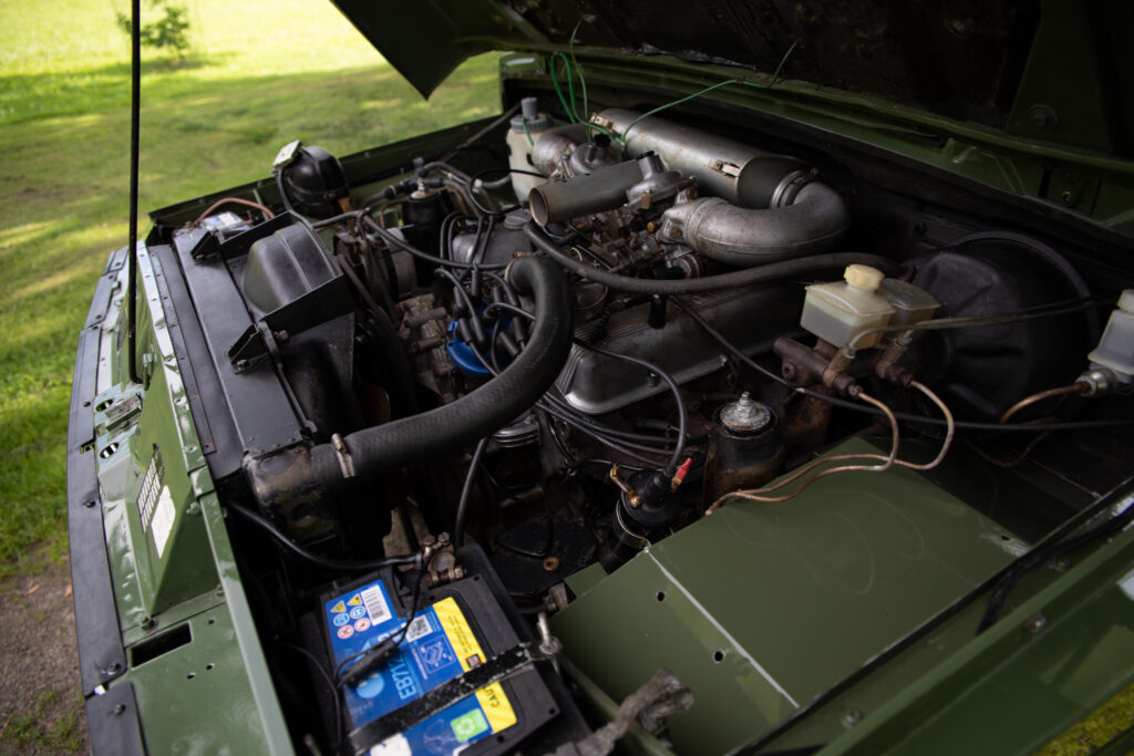 Open hood revealing classic vehicle engine bay