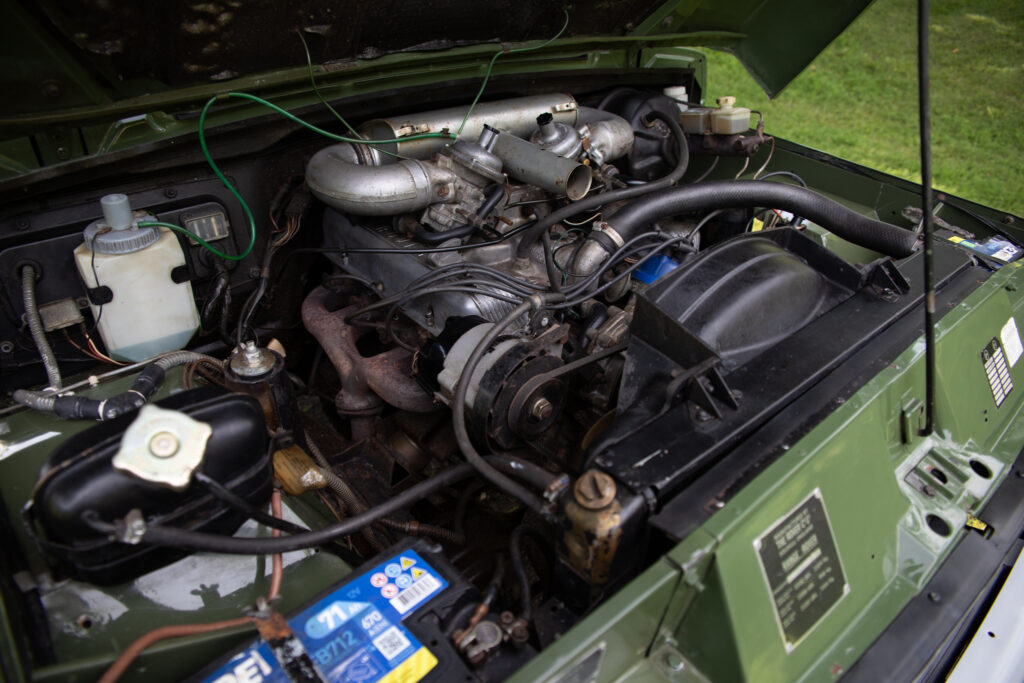 Open hood showing vintage vehicle engine bay